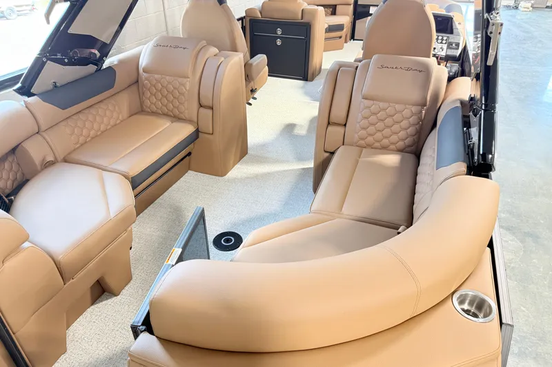 Slide: The Image of Luxurious interior of 2026 South Bay 525RS DC pontoon boat with tan leather seating. - 10