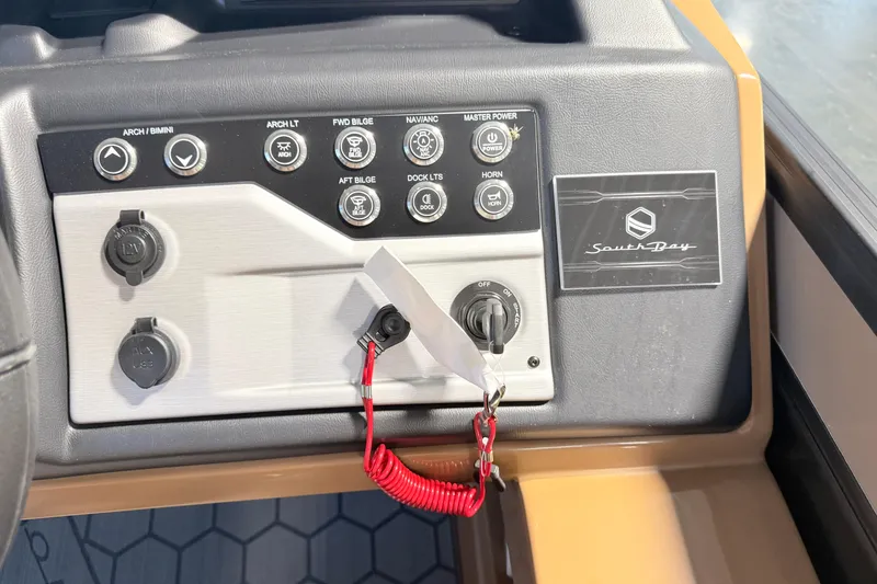 Slide: The Image of Control panel of 2026 South Bay 525RS DC boat with various switches and key ignition. - 18