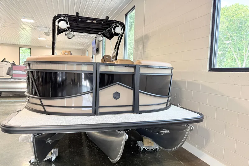 Slide: The Image of 2026 South Bay 525RS DC pontoon boat displayed indoors. - 2