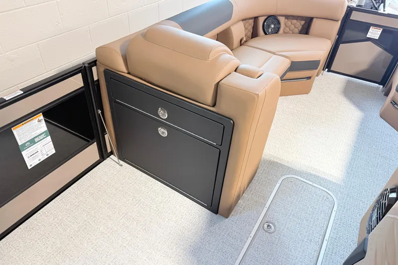 Slide: The Image of 2026 South Bay 525RS DC boat interior with tan seating and storage compartments. - 4