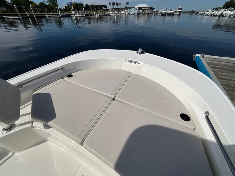 Slide: The Image of The image shows the bow of a 2027 Boston Whaler 210 Montauk, docked in calm waters. - 15