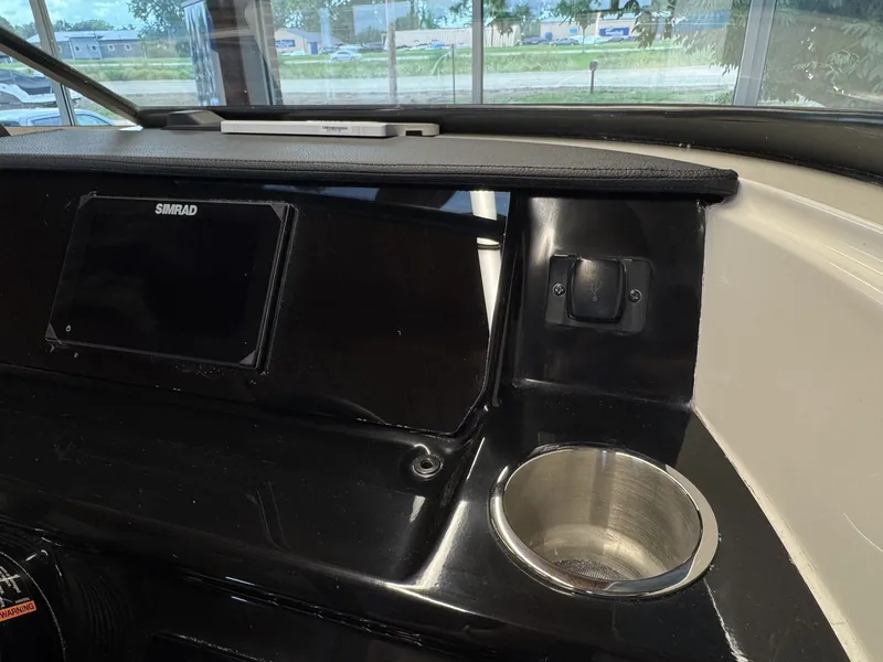 Slide: The Image of The image shows the dashboard of a Sea Ray SPX 210 boat with a Simrad display. - 12
