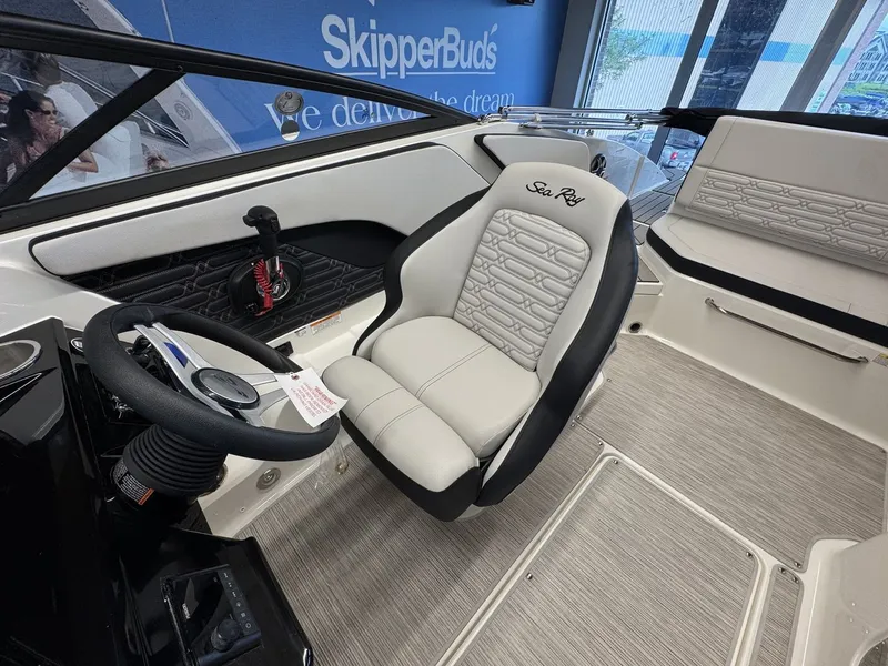Slide: The Image of The image shows the interior of a Sea Ray SPX 210 boat with a sleek white seat. - 9