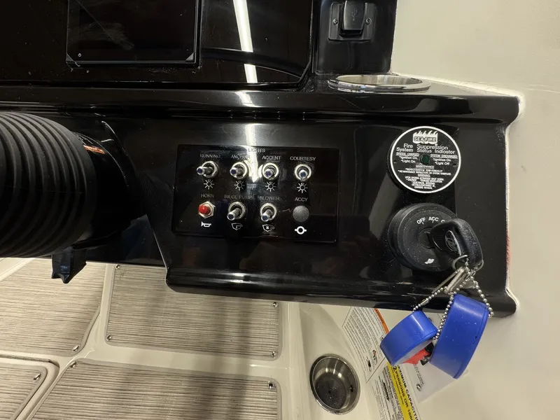 Slide: The Image of The image shows the dashboard of a Sea Ray SPX 210 boat with various switches and gauges. - 14