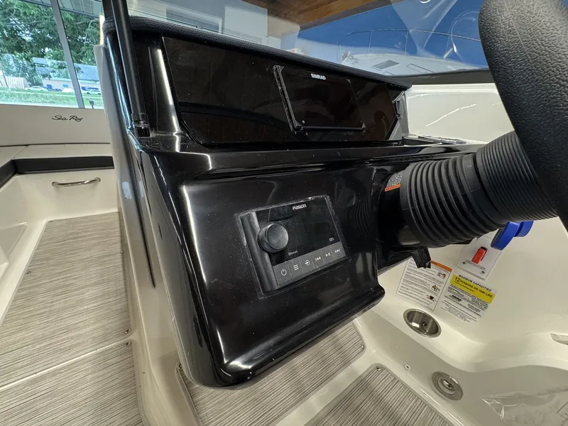Slide: The Image of The image shows the dashboard of a Sea Ray SPX 210 boat with modern controls. - 10