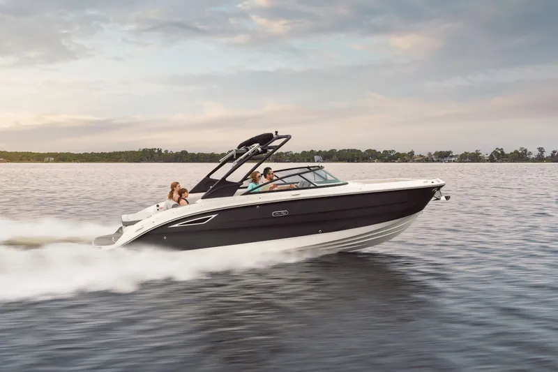 Slide: The Image of A 2026 Sea Ray SDX 270 boat speeds across the water, with several people on board. - 2