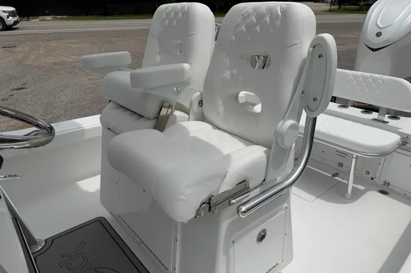 Slide: The Image of Luxury seating on 2026 BlackJack 256 Coastal boat, featuring plush white upholstery and armrests. - 13