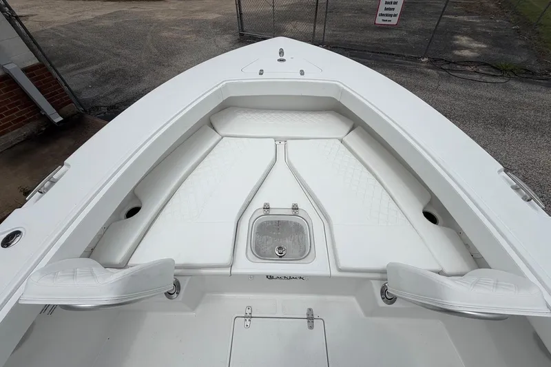 Slide: The Image of 2026 BlackJack 256 Coastal boat interior with white seating and storage compartments. - 7