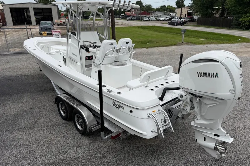 Slide: The Image of 2026 BlackJack 256 Coastal boat with Yamaha engine on a trailer in a parking lot. - 3