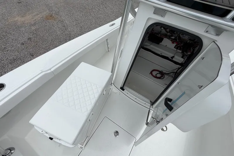 Slide: The Image of 2026 BlackJack 256 Coastal boat interior with open hatch and seating area. - 10