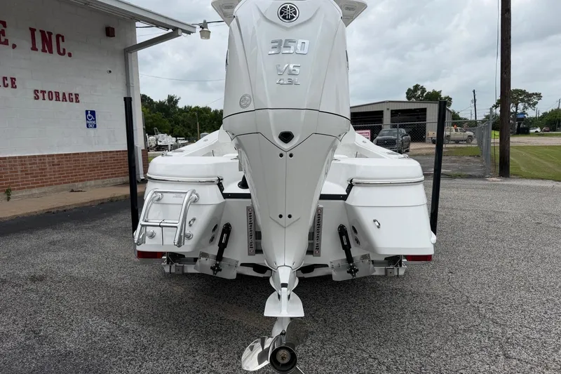 Slide: The Image of Rear view of a 2026 BlackJack 256 Coastal boat with a powerful outboard motor. - 16