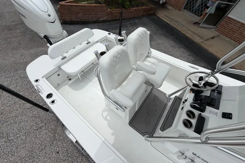 Slide: The Image of 2026 BlackJack 256 Coastal boat interior with white seating and modern helm controls. - 14