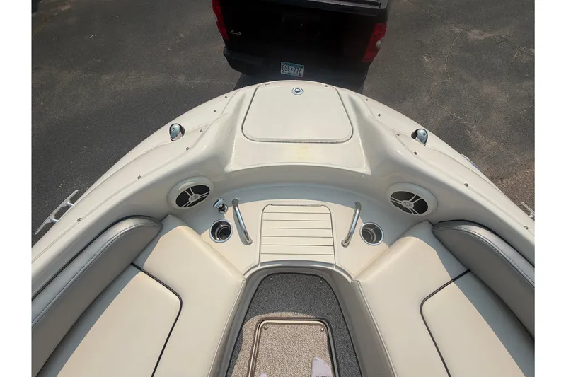 Slide: The Image of 2009 Sea Ray 240 Sundeck boat interior with seating and cup holders. - 11