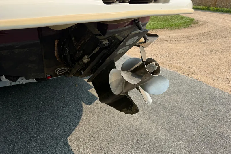 Slide: The Image of 2009 Sea Ray 240 Sundeck boat propeller on a paved surface. - 2