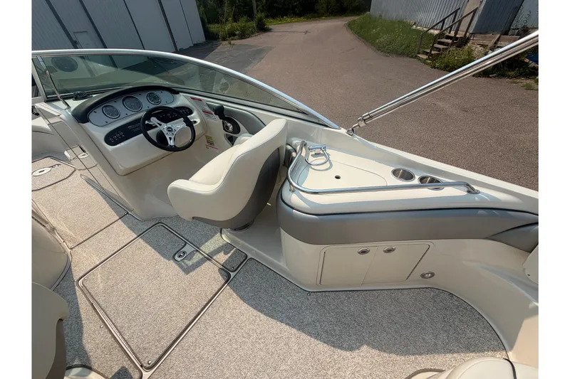 Slide: The Image of 2009 Sea Ray 240 Sundeck interior with steering wheel and dashboard, showcasing sleek design. - 15