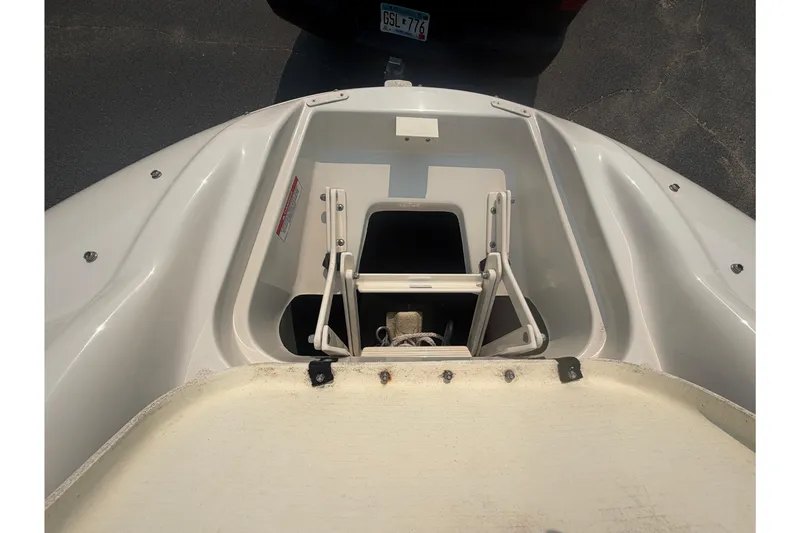 Slide: The Image of 2009 Sea Ray 240 Sundeck boat storage compartment with open hatch and visible anchor. - 12