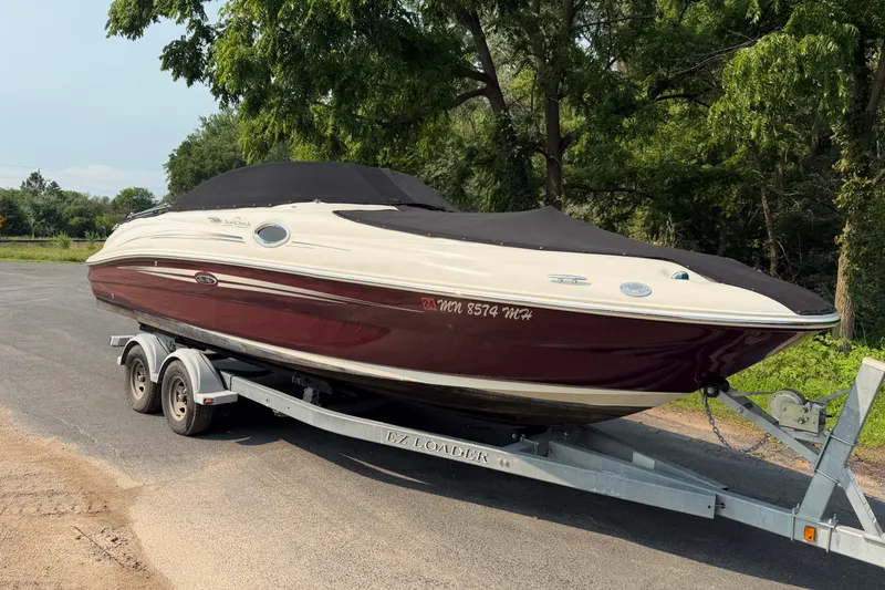 Slide: The Image of 2009 Sea Ray 240 Sundeck boat on trailer, parked outdoors. - 5
