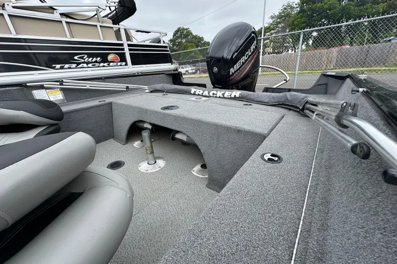 Slide: The Image of 2018 Tracker Pro Guide V-175 Combo boat interior with Mercury engine, featuring seating and storage. - 14