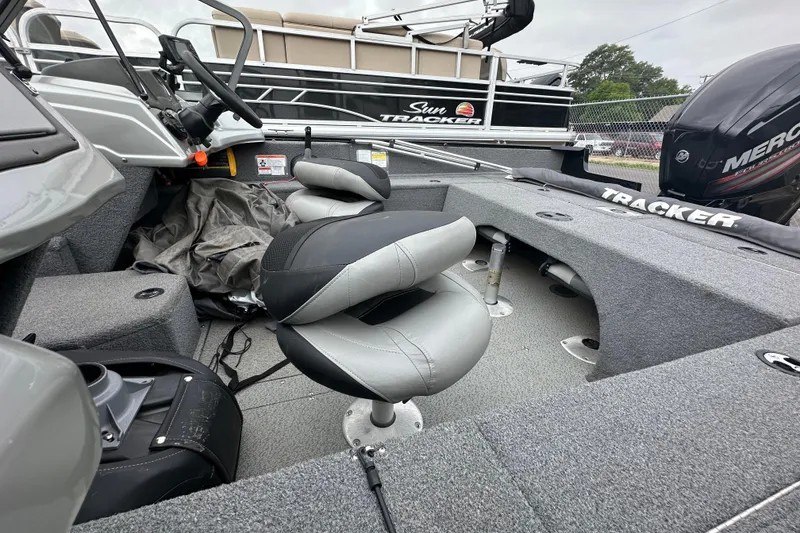Slide: The Image of 2018 Tracker Pro Guide V-175 Combo boat interior with seating and steering wheel. - 13