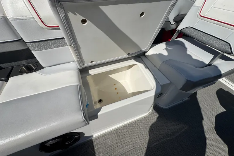 Slide: The Image of Open storage compartment on 2018 Formula 270 Bowrider boat with cushioned seating. - 13