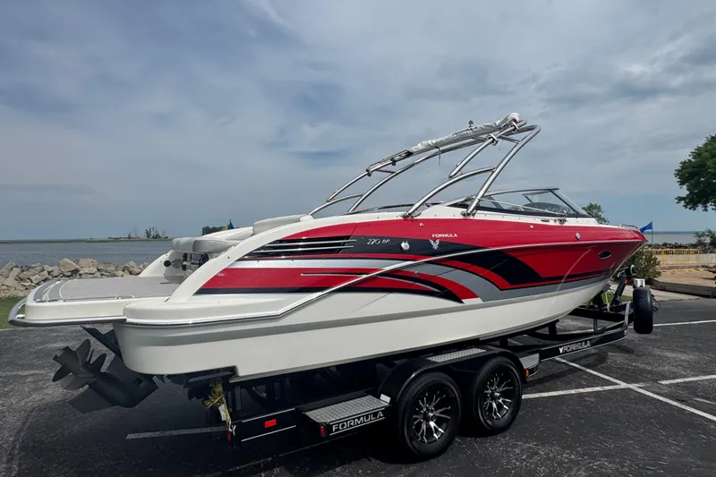 Slide: The Image of 2018 Formula 270 Bowrider boat on trailer, featuring sleek red and white design. - 5