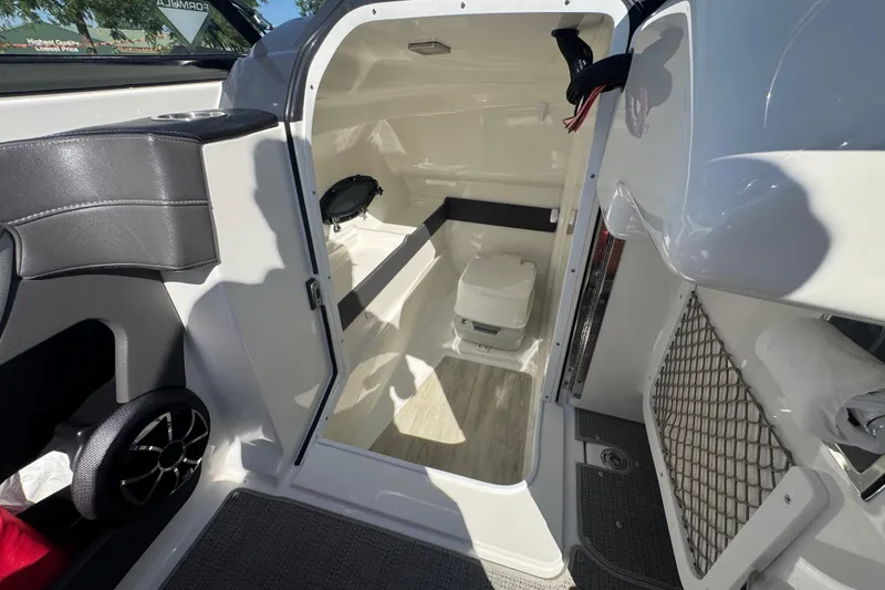 Slide: The Image of Interior of 2018 Formula 270 Bowrider boat showing compact cabin with toilet. - 15