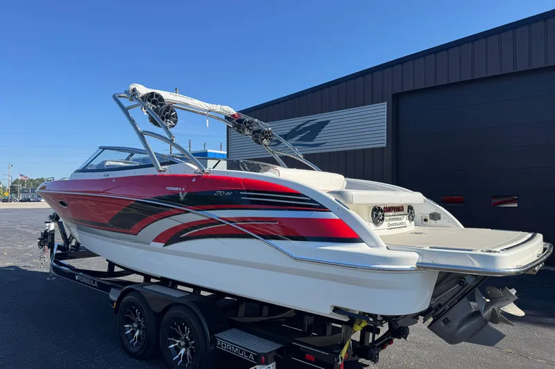 Slide: The Image of 2018 Formula 270 Bowrider boat with red and white design on a trailer. - 2
