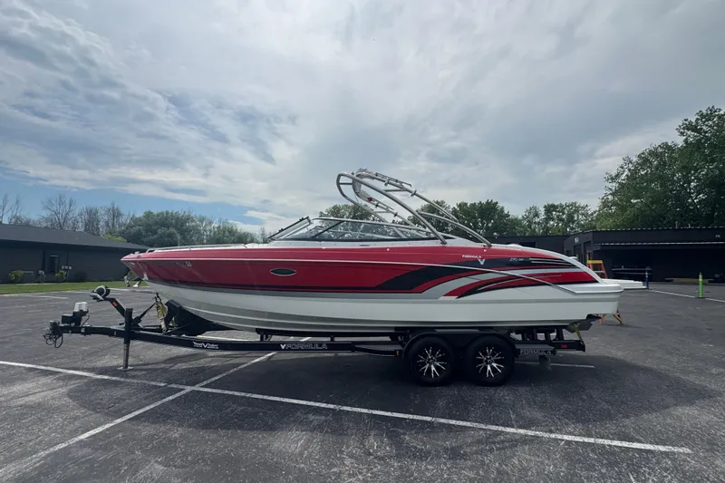 Slide: The Image of 2018 Formula 270 Bowrider boat on trailer, red and white design, parked outdoors. - 3