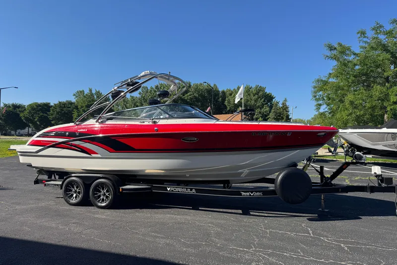 Slide: The Image of 2018 Formula 270 Bowrider boat on trailer, red and white design, parked outdoors. - 5