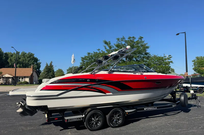 Slide: The Image of 2018 Formula 270 Bowrider boat on trailer, red and white design, parked outdoors. - 6