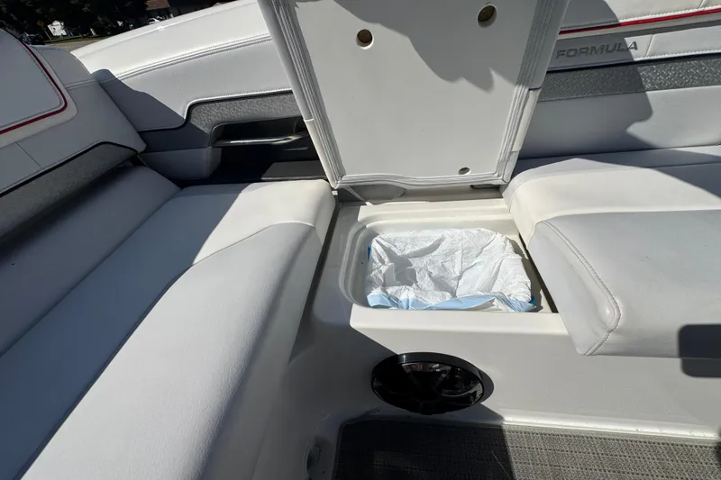Slide: The Image of 2018 Formula 270 Bowrider interior with open storage compartment and cushioned seating. - 12