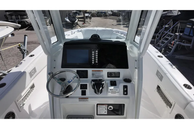 Slide: The Image of 2026 Sea Fox 268 Commander boat cockpit with steering wheel and control panel. - 6