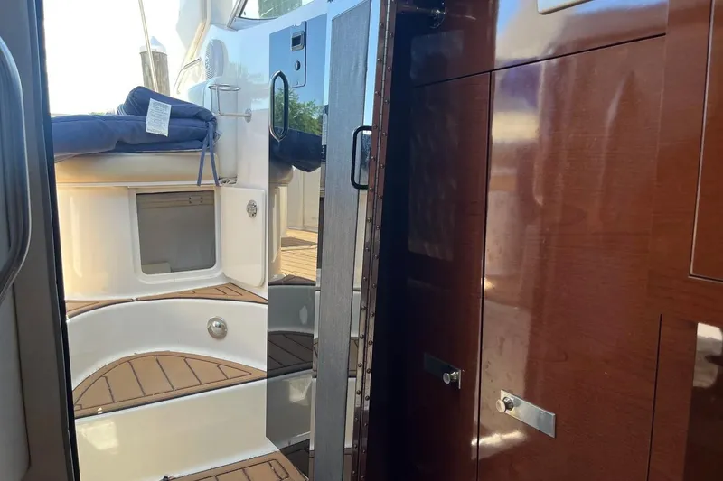 Slide: The Image of Interior view of 2010 Sea Ray Sundancer 260 yacht with wooden cabinetry and seating area. - 24