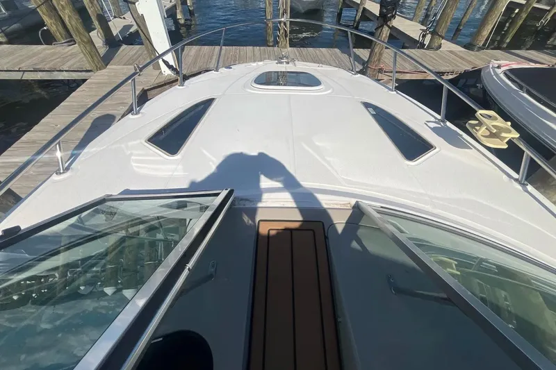 Slide: The Image of 2010 Sea Ray Sundancer 260 boat docked, viewed from the deck with open hatch. - 20