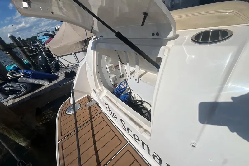 Slide: The Image of Open storage compartment on a 2010 Sea Ray Sundancer 260 boat docked at a marina. - 8