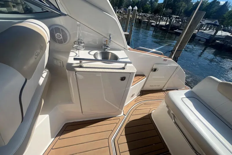 Slide: The Image of Interior of 2010 Sea Ray Sundancer 260 boat with sink and seating area. - 13