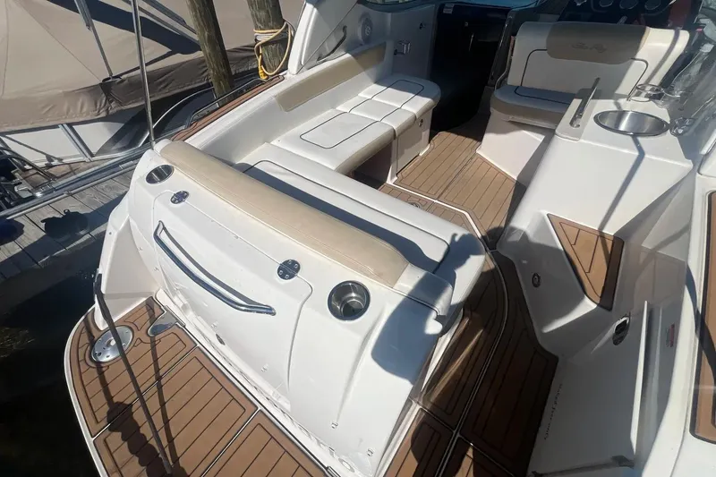 Slide: The Image of 2010 Sea Ray Sundancer 260 boat interior with seating and teak flooring. - 7