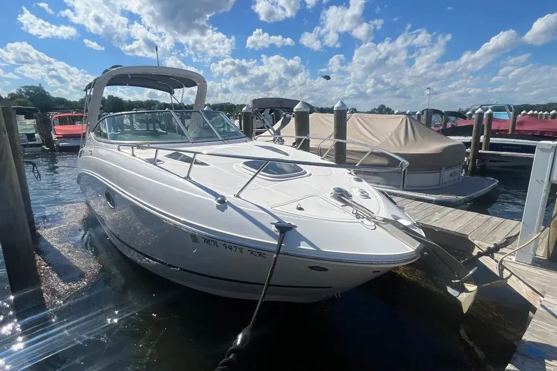 Slide: The Image of 2010 Sea Ray Sundancer 260 docked at marina under blue sky. - 4