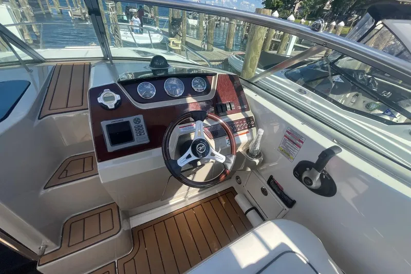 Slide: The Image of Helm of 2010 Sea Ray Sundancer 260 with gauges and steering wheel, dockside view. - 18
