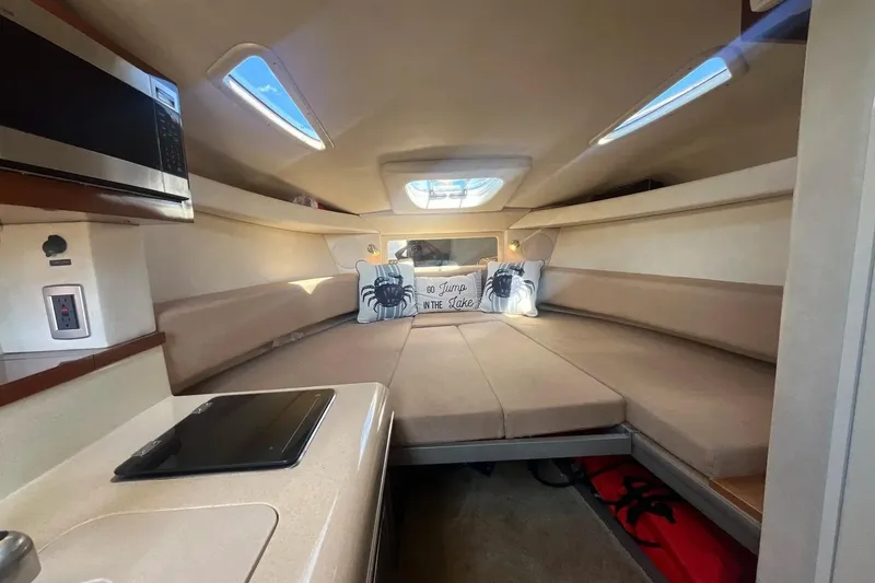 Slide: The Image of Interior of 2010 Sea Ray Sundancer 260 boat with cozy seating and modern amenities. - 26