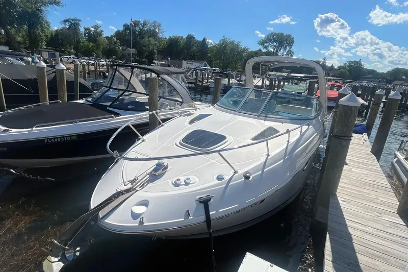 Slide: The Image of 2010 Sea Ray Sundancer 260 docked at a marina under a clear blue sky. - 3
