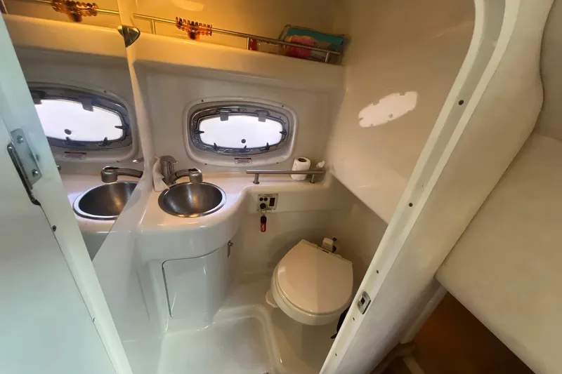 Slide: The Image of Compact bathroom in a 2010 Sea Ray Sundancer 260 boat with sink and toilet. - 29