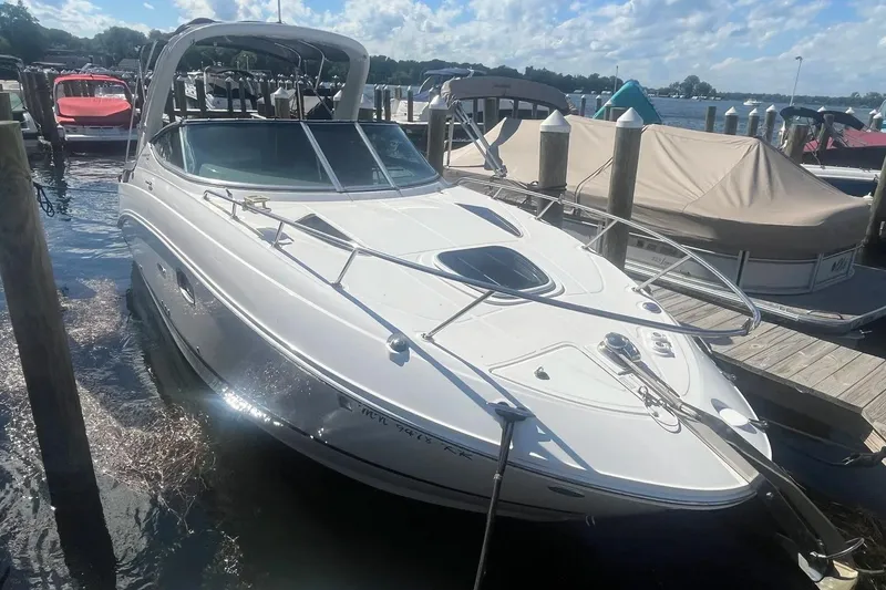 Slide: The Image of 2010 Sea Ray Sundancer 260 docked at marina under sunny skies. - 1
