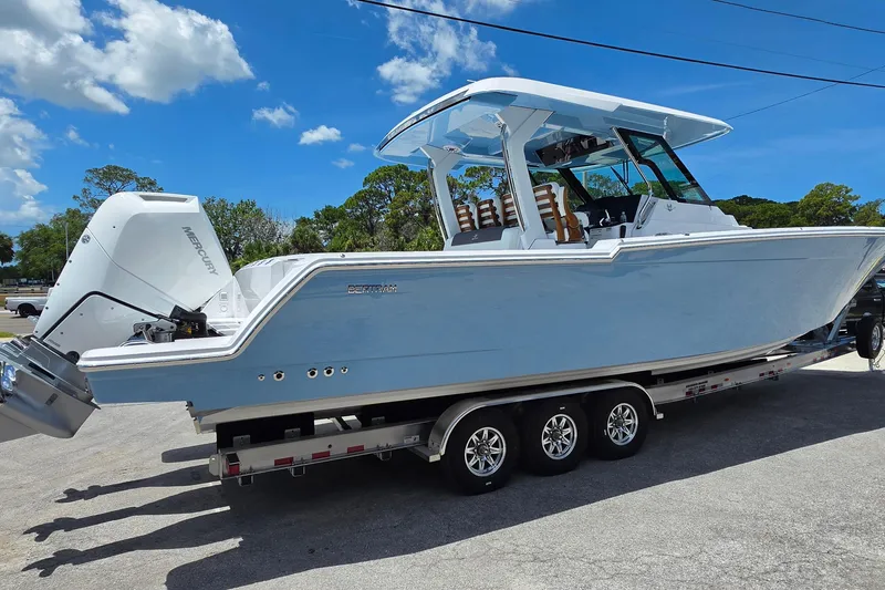 Slide: The Image of 2027 Bertram 39 CC boat on trailer, featuring sleek design and powerful Mercury engine. - 5