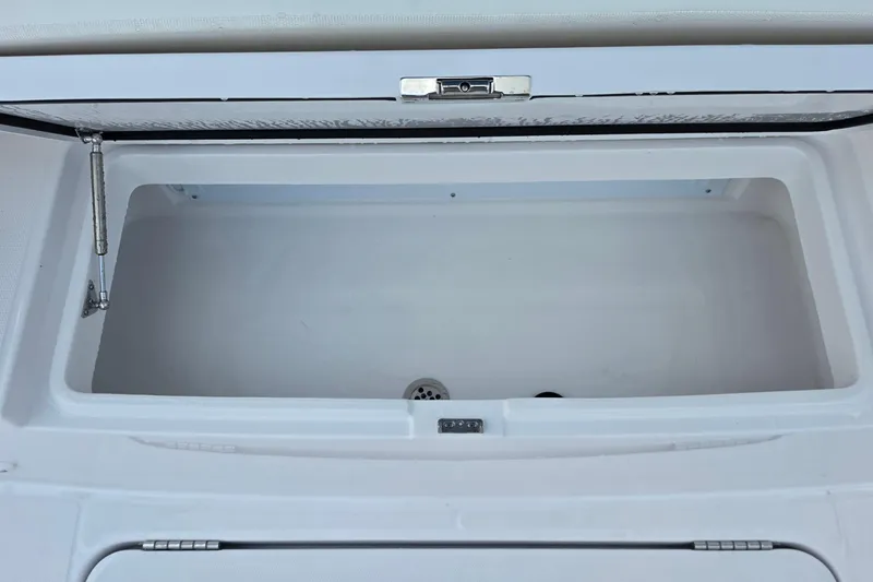 Slide: The Image of Open storage compartment on 2027 Bertram 39 CC boat, featuring a clean, white interior. - 27