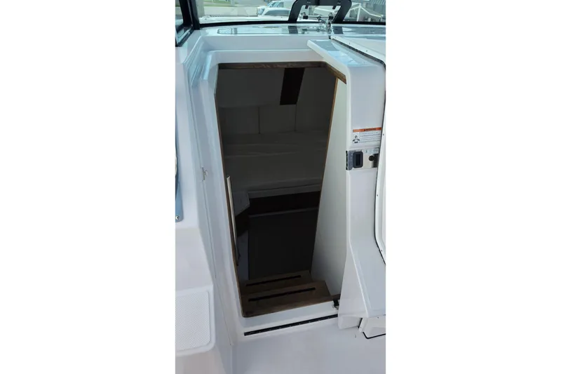 Slide: The Image of Entrance to cabin of 2027 Bertram 39 CC boat, featuring sleek white interior design. - 33