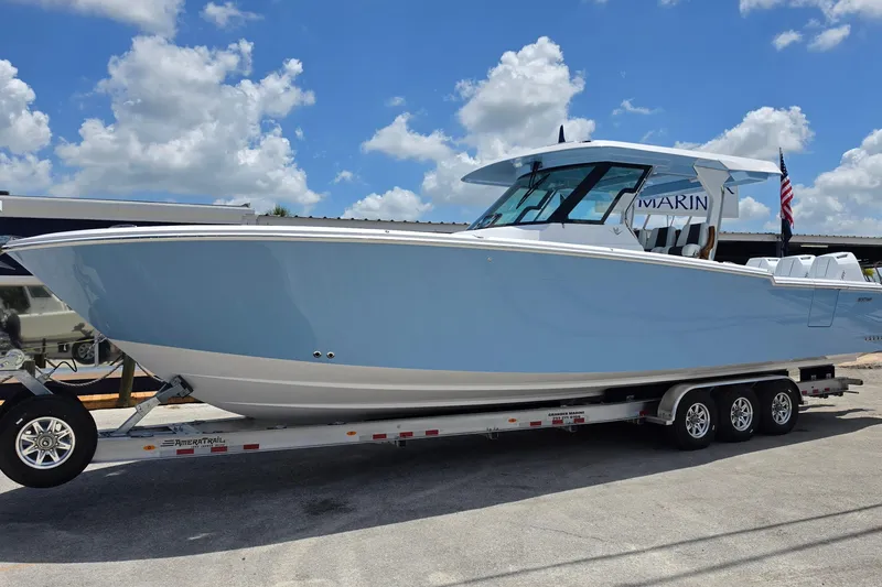 The Image of 2027 Bertram 39 CC boat on trailer under blue sky. - 1