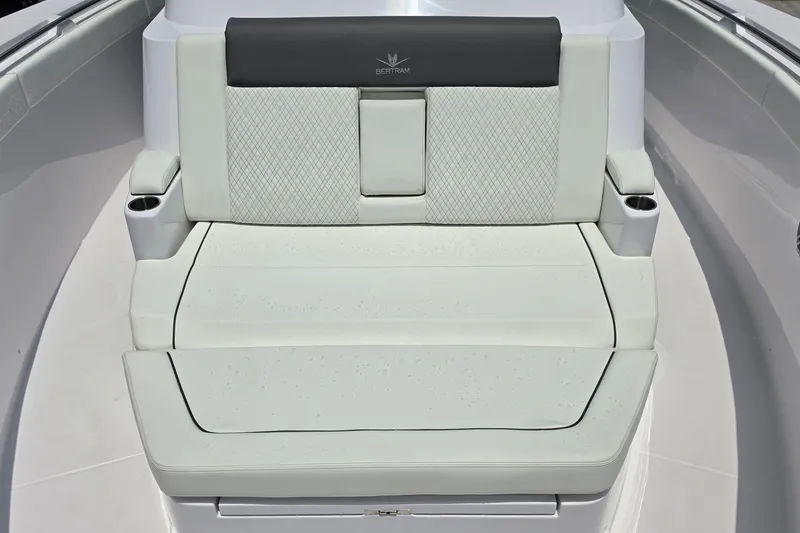 Slide: The Image of 2027 Bertram 39 CC boat seat with cup holders and elegant upholstery design. - 19
