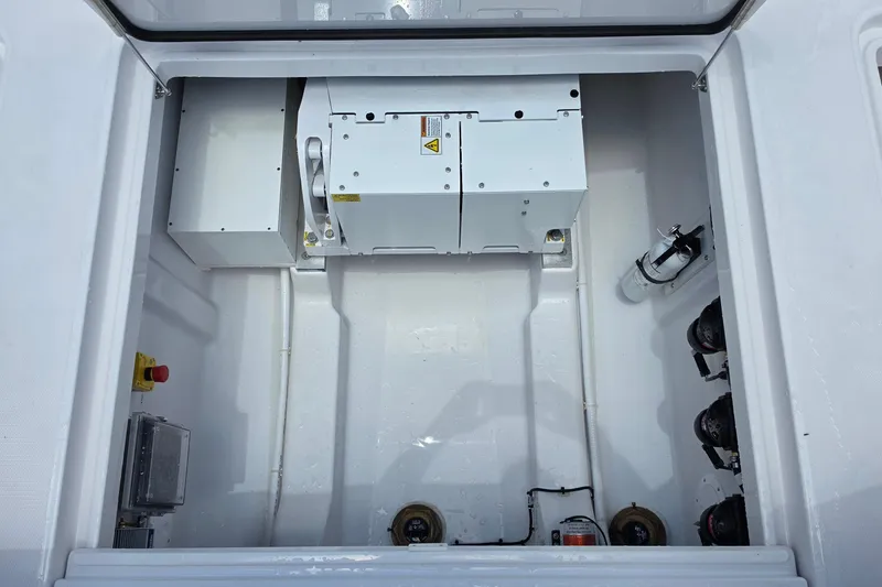 Slide: The Image of Engine compartment of 2027 Bertram 39 CC boat, featuring mechanical components and safety equipment. - 9