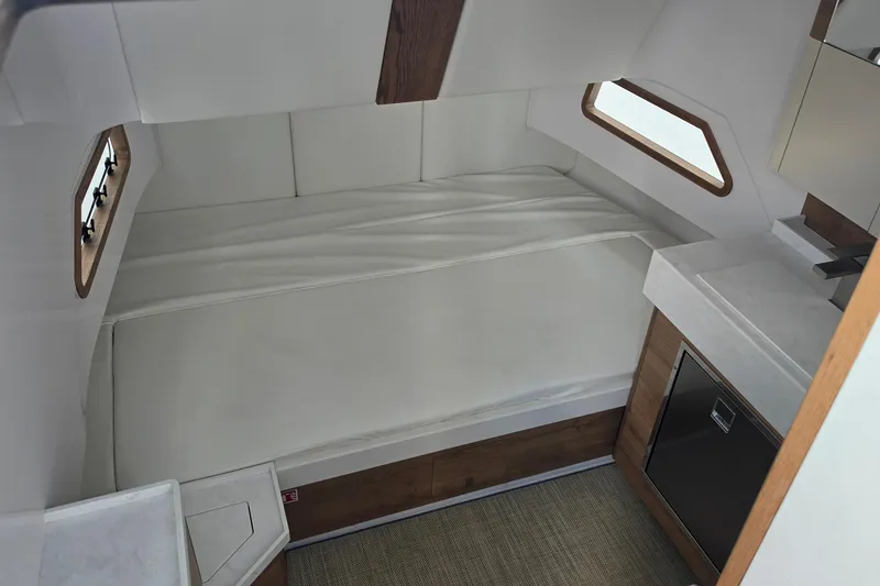 Slide: The Image of Interior cabin of 2027 Bertram 39 CC boat with white bedding and wooden accents. - 35
